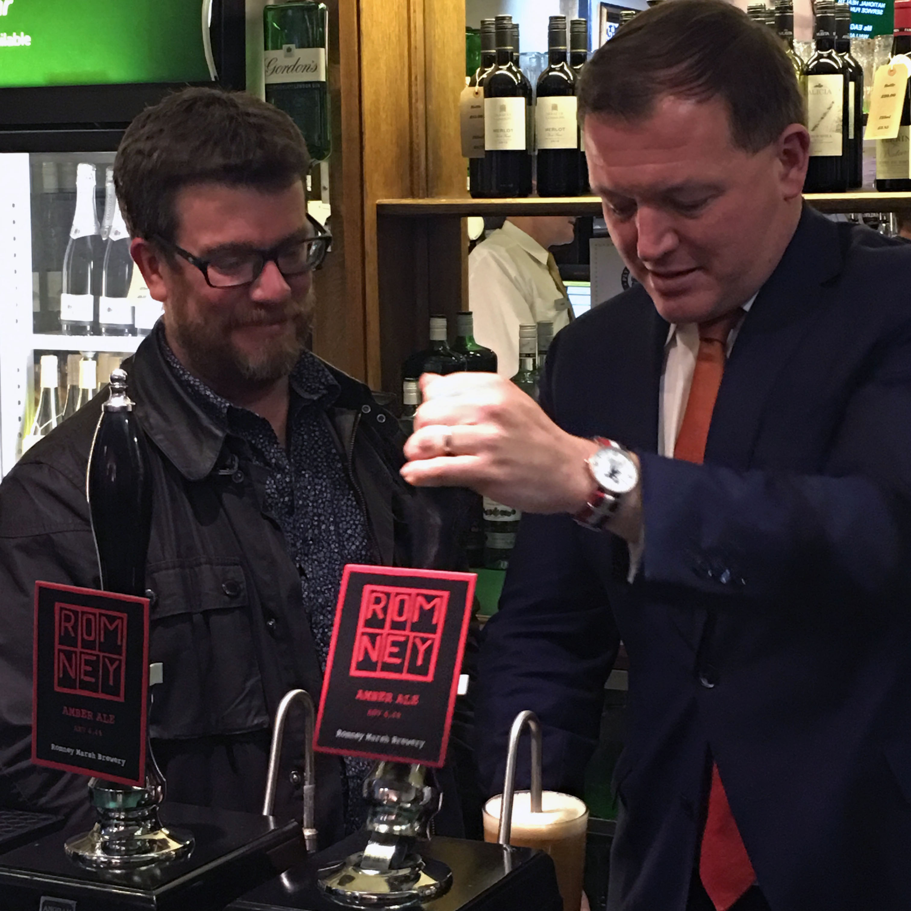 Local MP Damian Collins pours a pint of Romney Amber at House of Commons